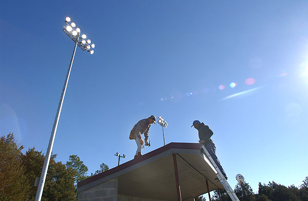 Putting roof on new softball dugouts