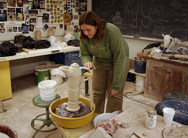 Ceramic student working on teapot