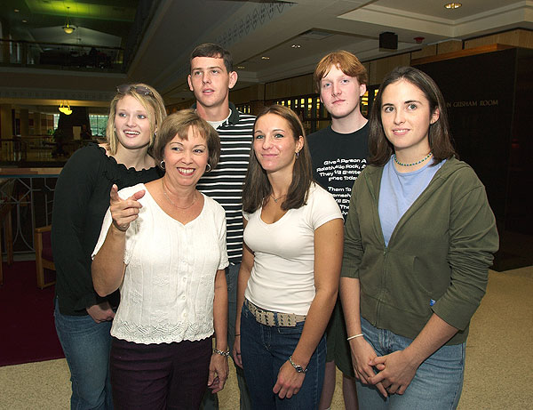 Linda Martin shows students library