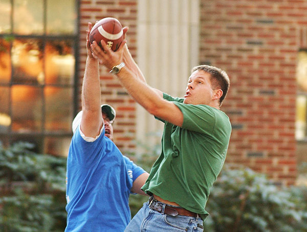 Students playing catch with a football