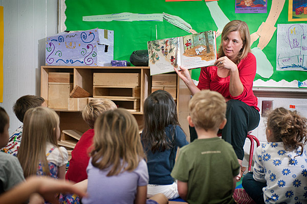 Devon Brenner reads to Aiken Village Preschool children