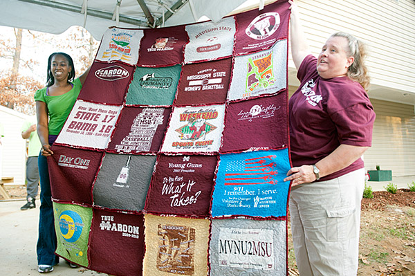 Presenting t-shirt quilt to Habitat homeowner