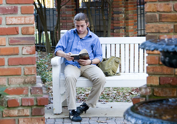 Student reading by chapel