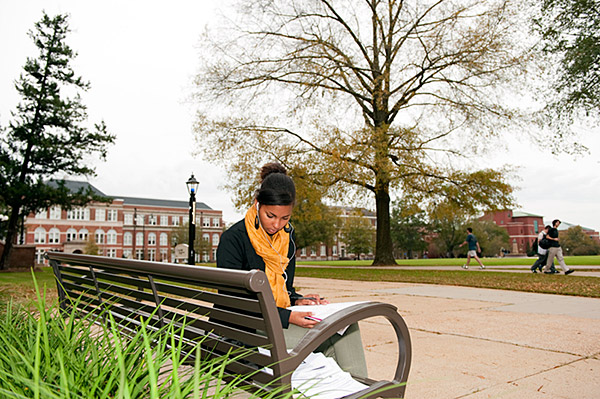 Studying on a bench outside of Lee Hall