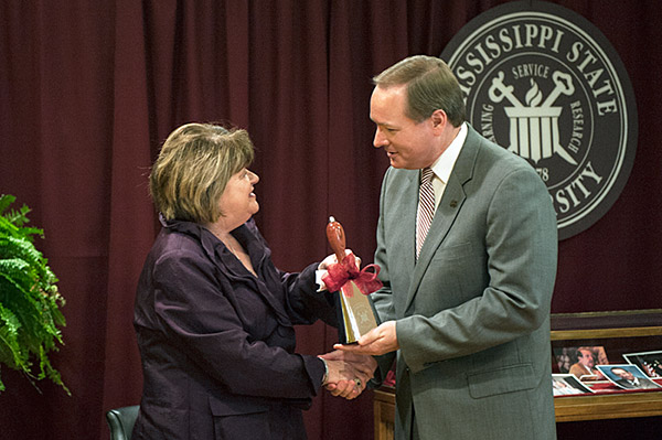 President Keenum presents cowbell to Mrs. Gordon