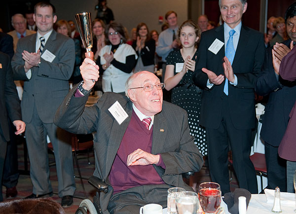 Don Zacharias rings cowbell at Alumni Banquet