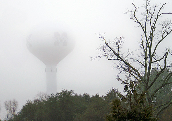 Water tower surrounded by fog