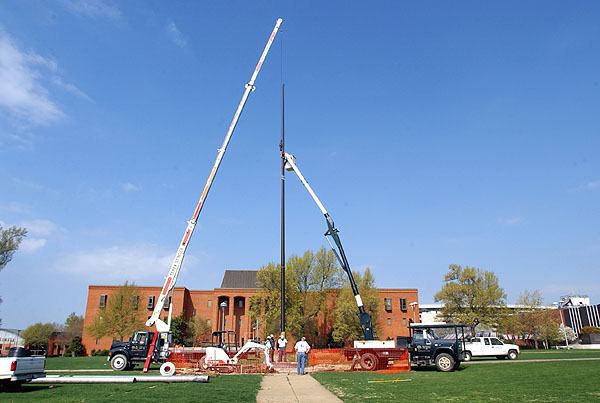 Installing new flag pole on Drill Field