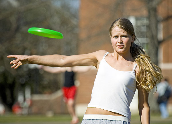 Throwing frisbee on drill field