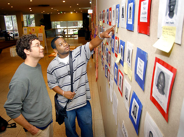 Students looking at active military wall in Union