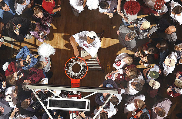 Cutting down basketball nets after capturing SEC title