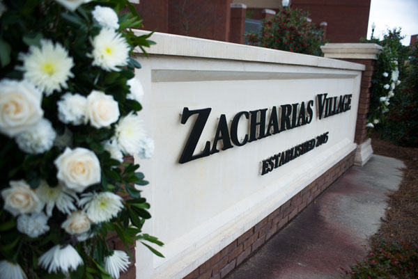 Zacharias Village Sign With Flowers