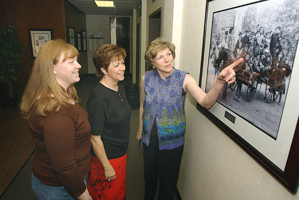 Looking over photo exhibit at 6th floor Allen Hall