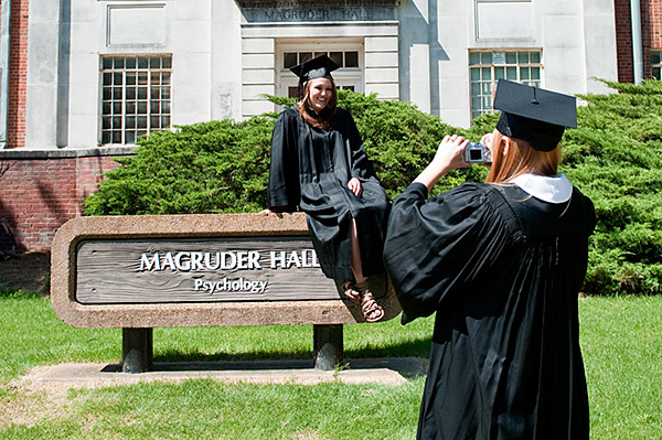 Graduates pose for photos at Magruder Hall