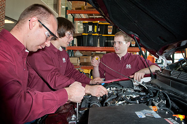 Eco car team working on engine