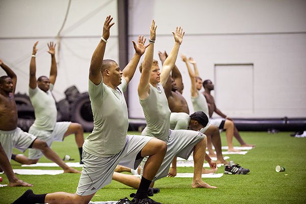 Football team enjoying yoga instruction