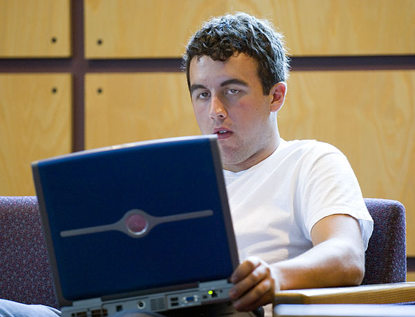 Student working on laptop in library