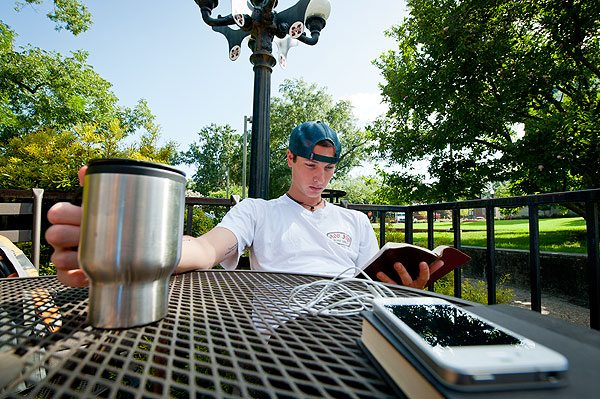 Student reading at Bakery courtyard