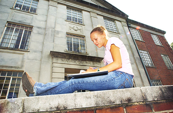 Student studying outside Magruder Hall