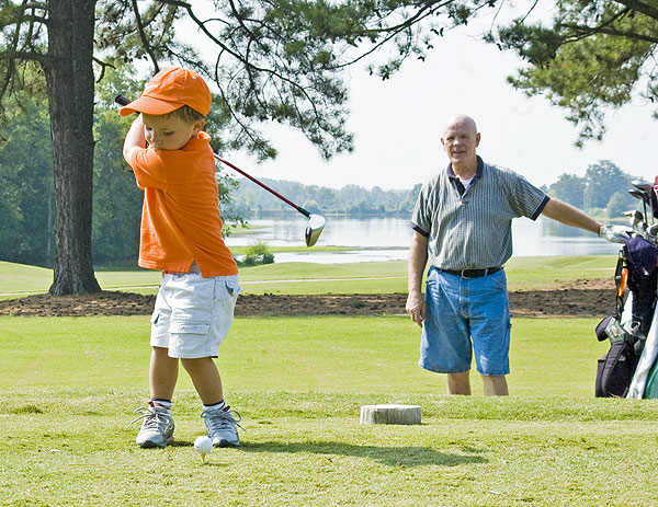 Boy and grandfather play golf at MSU course