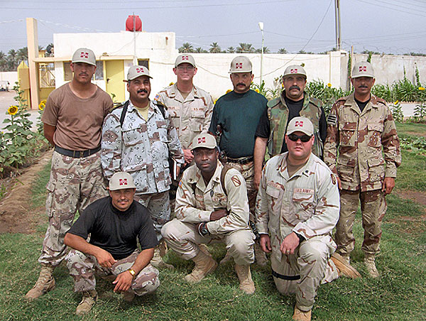 Troops in Iraq wearing MSU hats