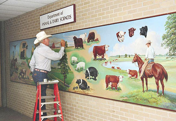 Artist touches up painting of South Farm