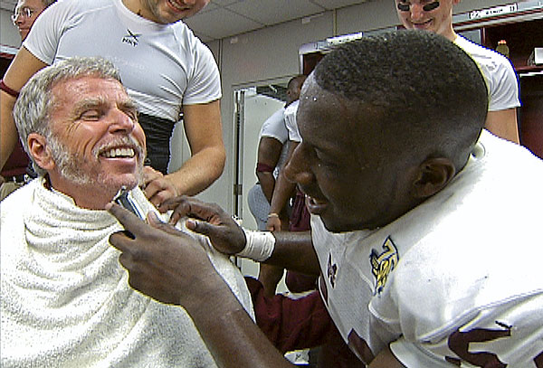 Doc gets a clean shave from a football player