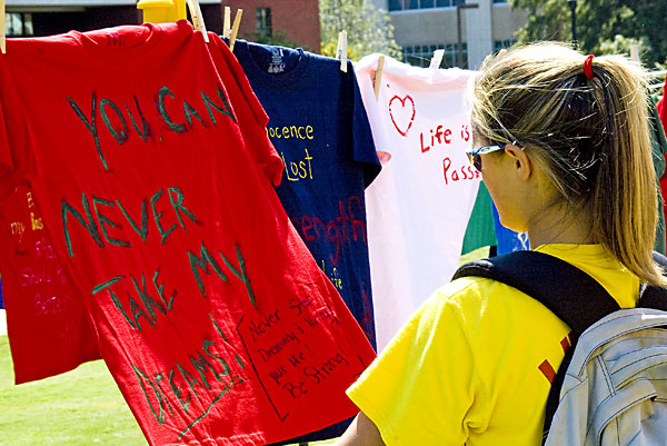 browsing t-shirts at the Clothesline project