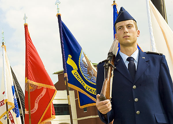 ROTC Cadet stands guard over flags