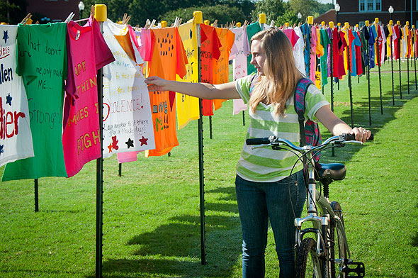 Student looking at Clothesline Project on Drill Field.