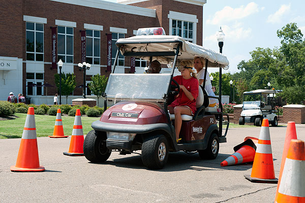 Students participating in a drunk driving simulation