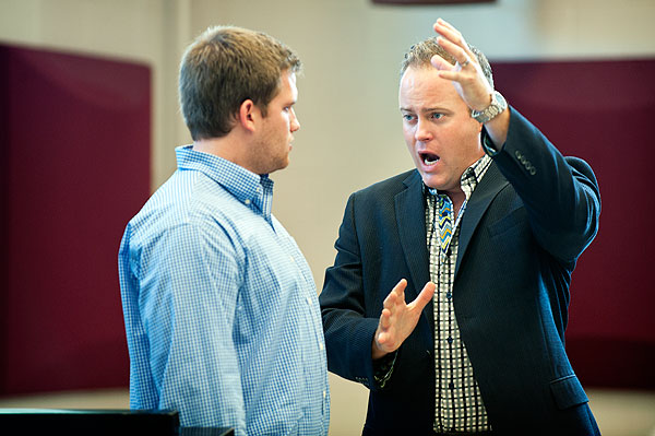 Alum Cory McKern instructing choral students