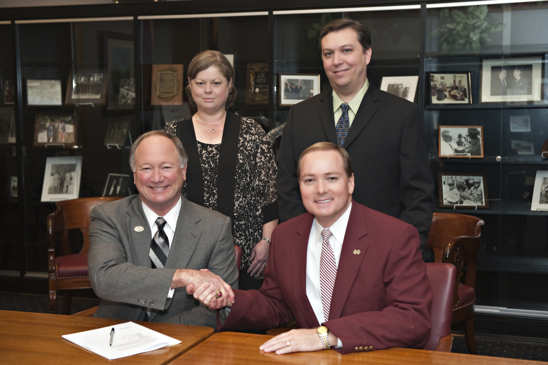 Presidents Rick Young of EMCC (l) and Mark Keenum of MSU recently marked the formal participation of the community college in the Golden Triangle Regional Library Consortium.  EMCC's Donna Ballard and MSU's Stephen Cunetto, library staff members at the respective institutions, also were part of the program.