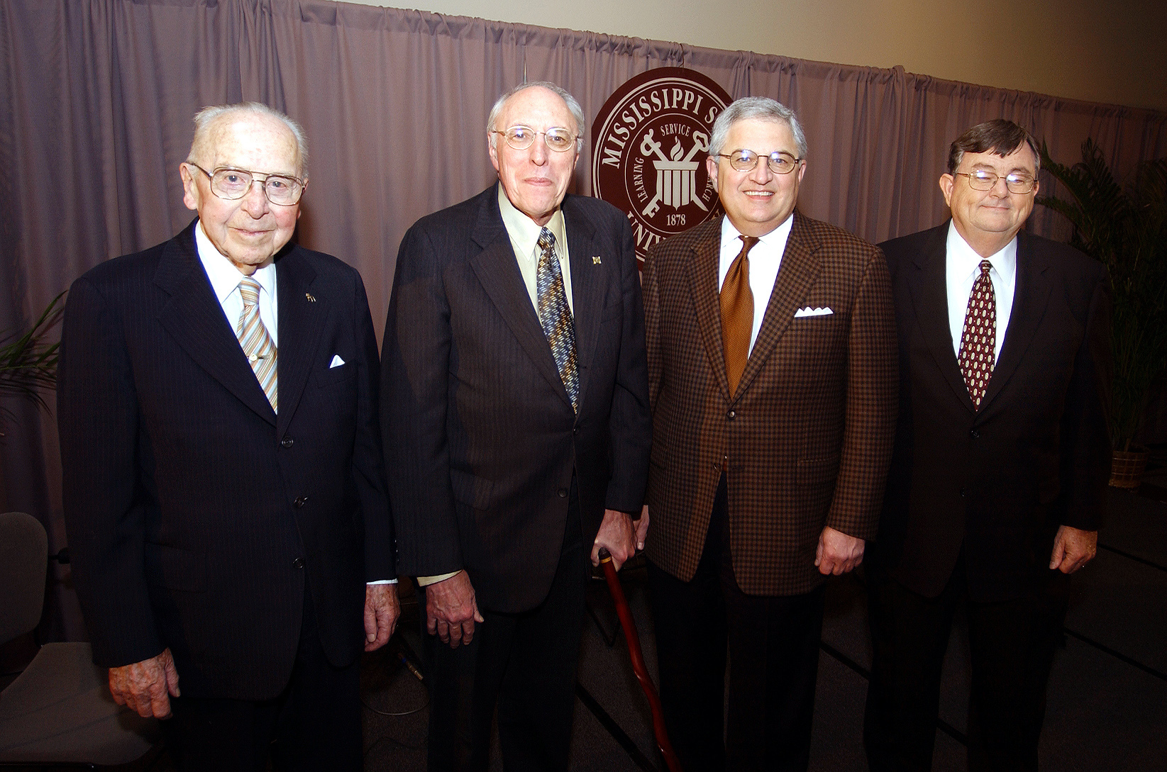 <br /><br />
Celebrating Mississippi State University's 125th anniversary, all four living former and current presidents were on campus Feb. 28, 2003, for Founders Day activities. Participating in a program at the Hunter Henry Center are from left, Dean W. Colvard, Donald W. Zacharias, Malcolm Portera, and current MSU President J. Charles Lee. 