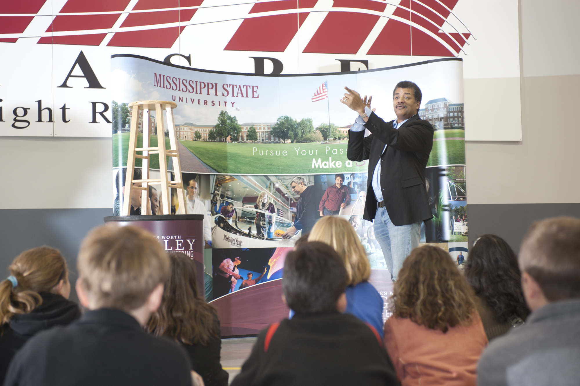 Astrophysicist Neil deGrasse Tyson wowed local elementary and middle school students Tuesday, answering questions from "Why isn't Pluto a planet?" to "What will happen when plasma from the sun hits earth?"