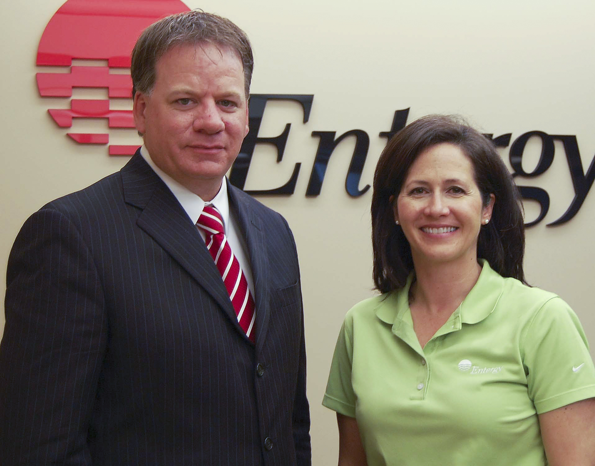 Jack McCarty, executive director of the Mississippi State University Foundation, accepts a check from Liz Brister, Entergy Mississippi's manager of external affairs, for support of Economy Watch, a College of Business magazine.