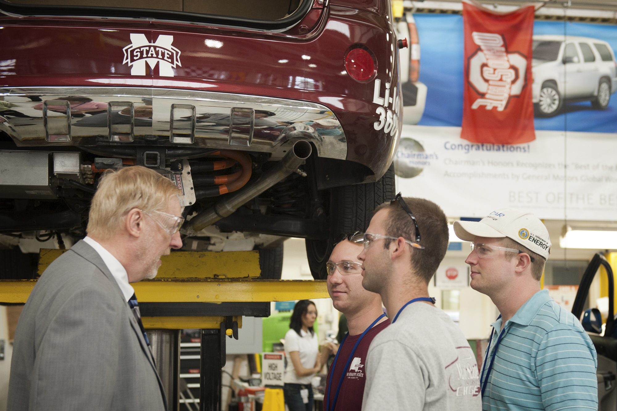 During the 2011 EcoCar competition, General Motors vice chairman and global chief technology officer Thomas Stephens, left, visits with members of MSU's EcoCar team, including, left to right, Matthew Doude of McCool, Julian McMillan of Brookhaven, and Brian Benoy of Dallas, Texas. 