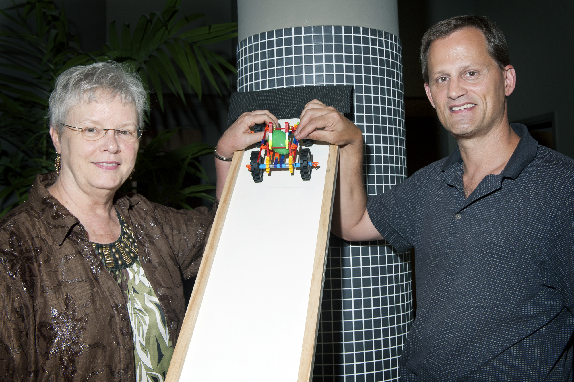 Rosemary Cuicchi and Mark F. Horstemeyer of the Center for Advanced Vehicular Systems demonstrate a model vehicle used in the Mission Eggcellence Challenge, an MSU program using the physics of automobile crashes to teach the importance of seatbelt use.