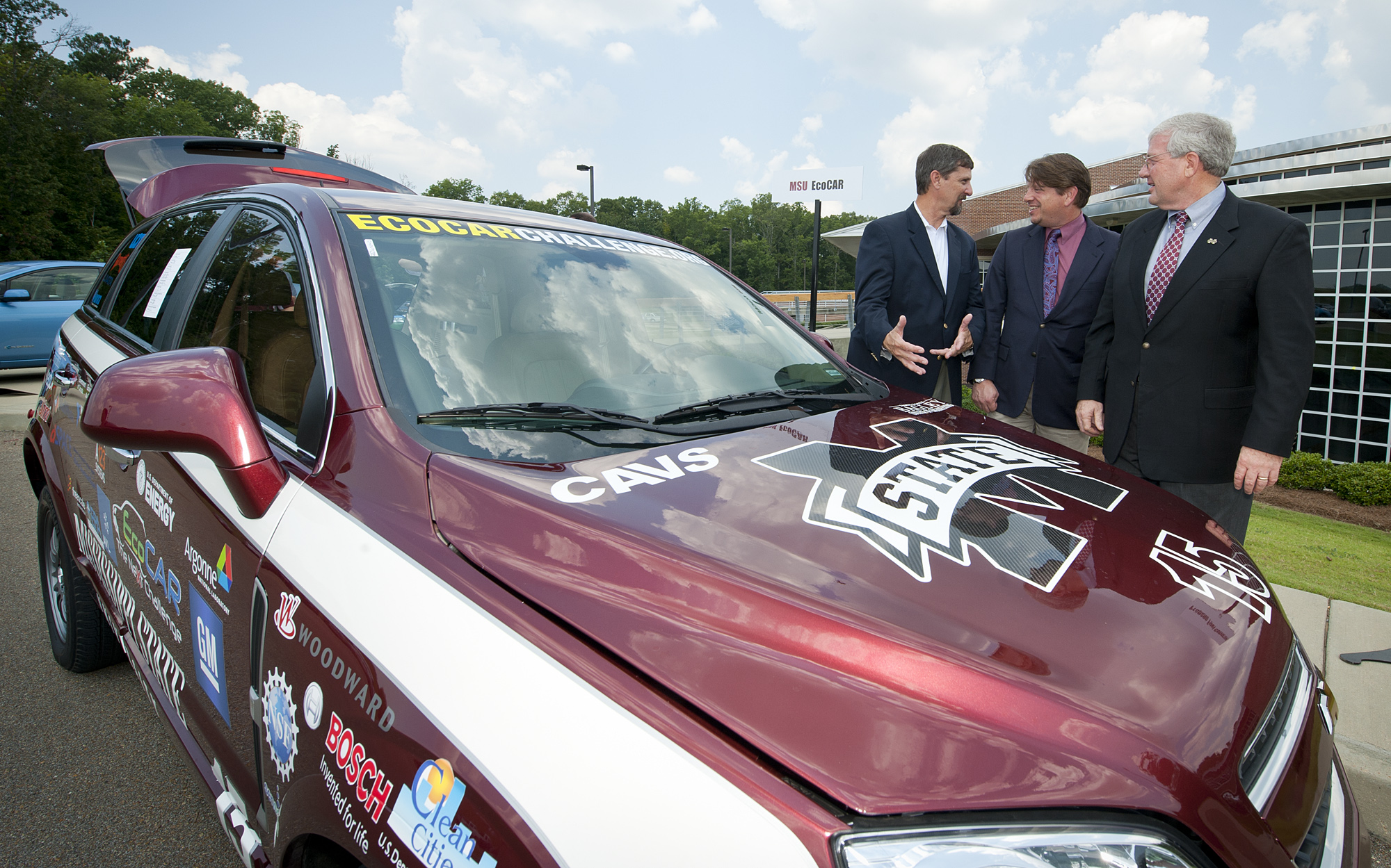 Mark Denton, vice president of business development for Alliance AutoGas, speaks with Mike Mazzola and Roger King, associate director and director of Mississippi State's Center for Advanced Vehicular Systems. Business, university and state leaders met at the university center on Tuesday to discuss economic development opportunities of university research. 