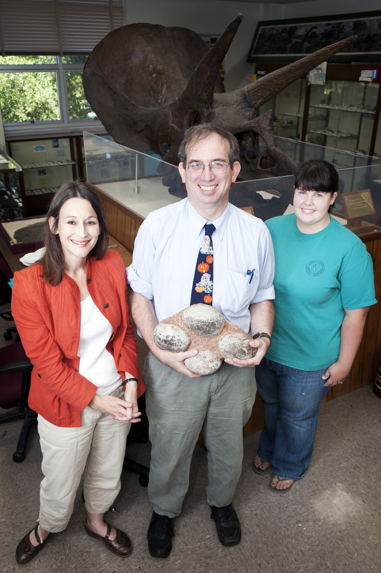 Doctoral student John Paul Jones (c) holds dinosaur eggs he discovered that will be on display Wednesday during "Fossil Extravaganza 2011" at MSU's Dunn-Seiler Museum. With him are museum director Renee Clary (l) and student worker Jessica Kelly of Pontotoc. 