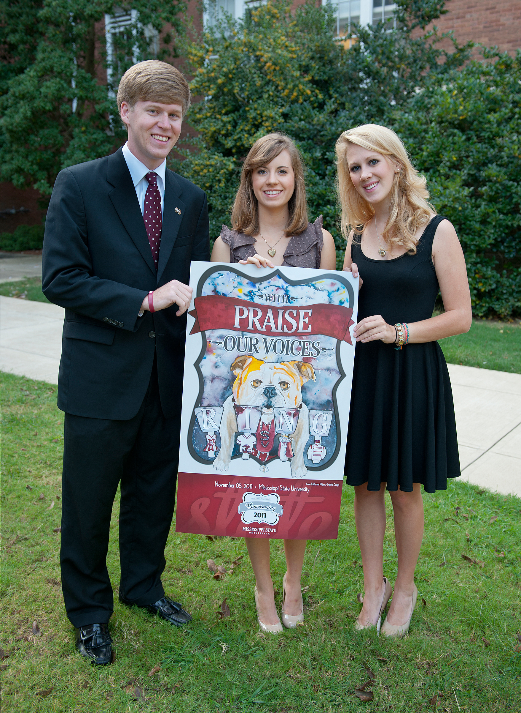 Senior art major Anna Katherine Phipps, center, is the winner of this year's homecoming poster design contest. Phipps is congratulated by Rhett Hobart, MSU Student Association president, and Brittany White, SA director of student activities.