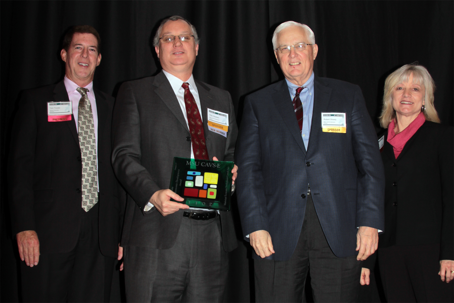 MSU's Clay Walden and Robert Sheely (center left and right, respectively) accept the Community Economic Development Award from MEDC board president Tom Troxler (left) and MEDC executive director Carol Hardwick. Troxler is executive director of the Rankin First Economic Development Authority.