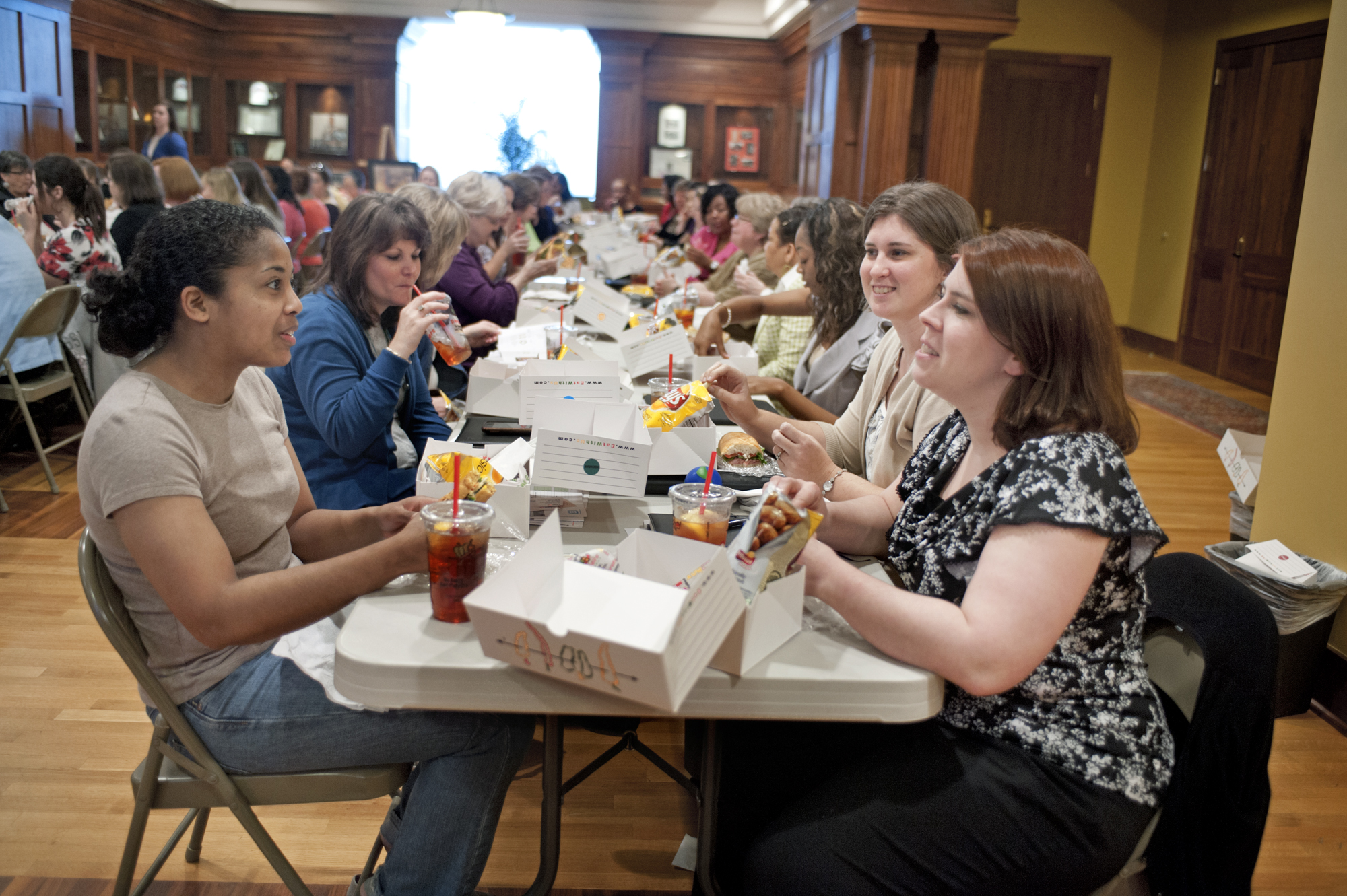 MSU graduate student Sheena Gardner, left, visits with sociology faculty member Kimberly Kelly, right, during the recent Food for Thought luncheon presented by the President's Commission on the Status of Women. The event, which focused on "Financial Planning for Women," drew a record crowd, and organizers said the luncheon was just one of many activities designed to engage more women on campus and discuss issues of importance to them.<br /><br />
