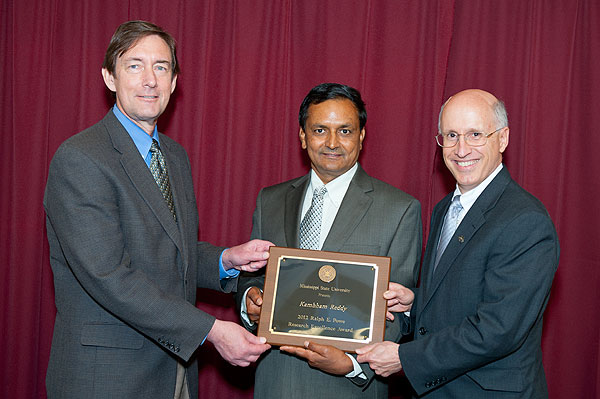 Plant and Soil Sciences Research Professor Kambham "Raja" Reddy, center, was recognized recently at the MSU Research Awards Banquet with the Ralph E. Powe Research Excellence Award, the highest honor given. His research focuses on environmental control of plant growth and development, crop simulation model development and applications, and global change biology and remote sensing applications in natural resource management. Presenting Reddy with the award are Gregory Bohach, left, vice president for agriculture, forestry and veterinary medicine, and David Shaw, right, vice president for research and economic development.   