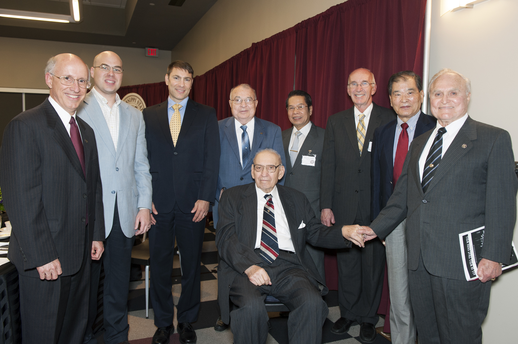 Janos Radvanyi, seated, center, surrounded by friends and speakers at the banquet and reception in his honor. 