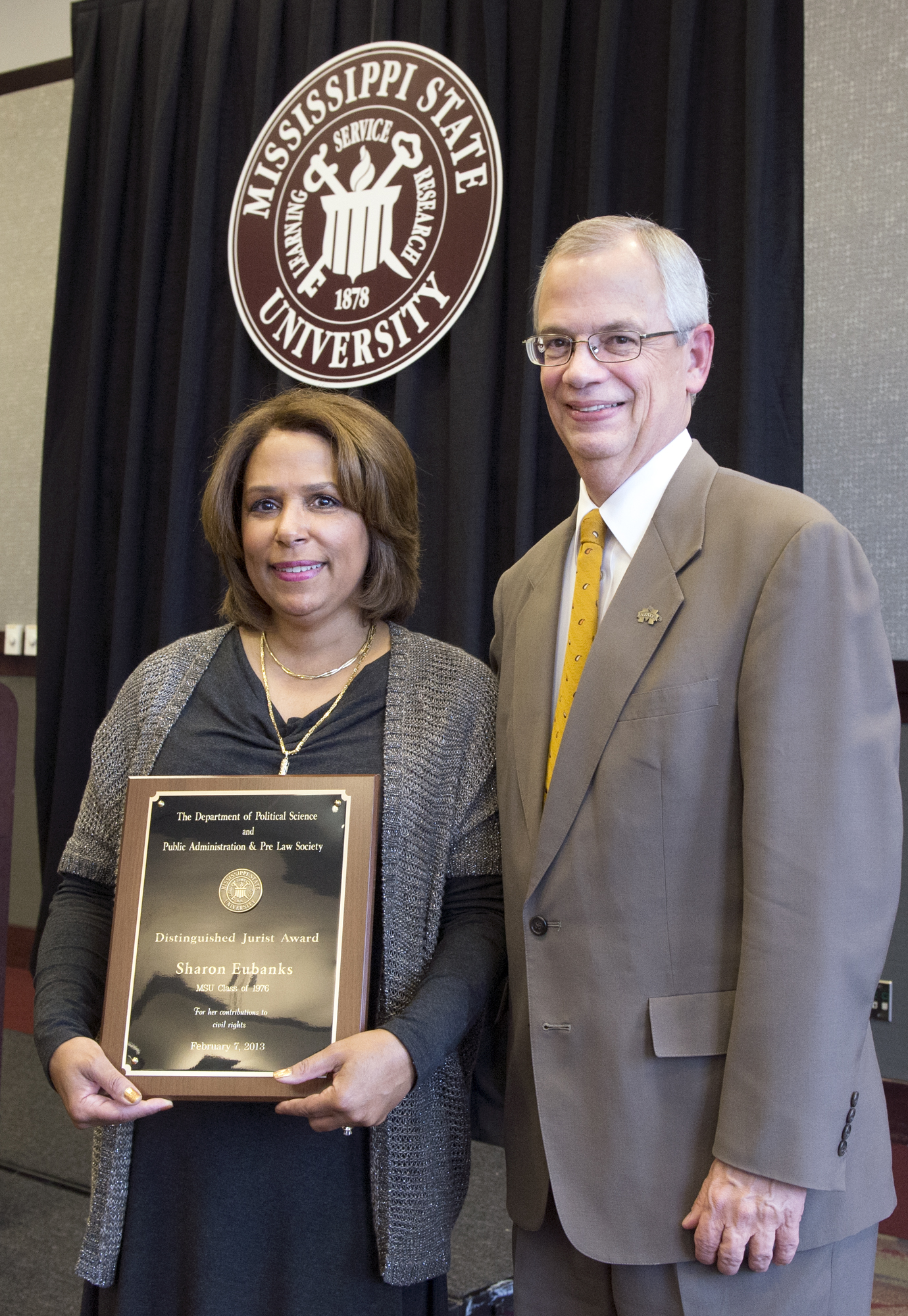 Alumnus and attorney Sharon Eubanks receives the MSU Distinguished Jurist Award from Jerry Gilbert, provost and executive vice president. The annual award is given by the university's political science and public administration department and by the MSU Pre-Law Society.