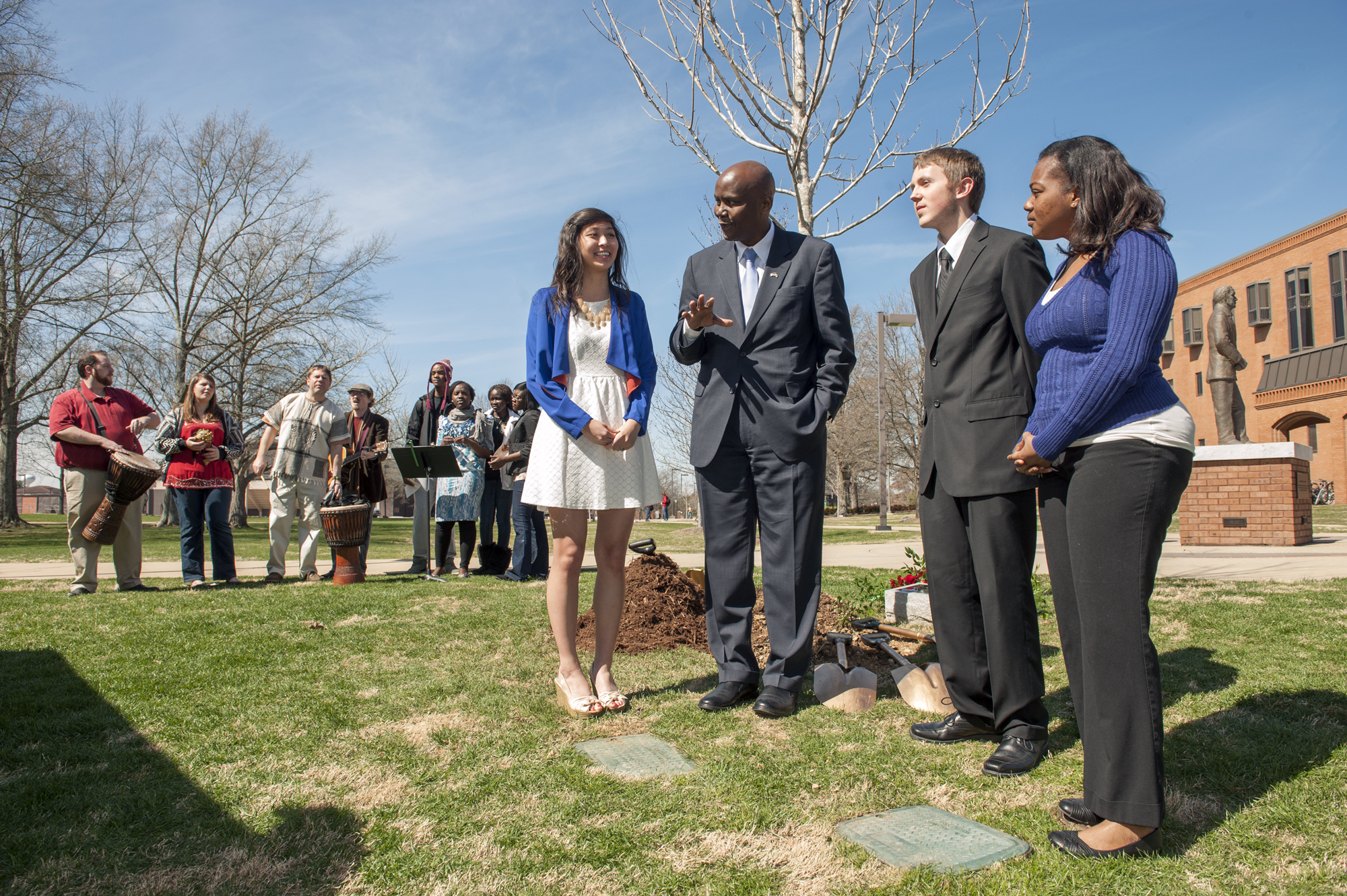 Kenyan Ambassador Elkanah Odembo, center, visits with three Mississippi State student winners of an essay contest the university held in conjunction with the reading of "Unbowed," by Wangari Maathai. The ambassador knew fellow Kenyan Maathai well, and he said the ceremonial tree planting in her memory at MSU Monday also was an appropriate way to honor Kenya, which held its first election since approval of its new constitution. As members of the African Student Association perform in the background, chemistry major Catherine Feng, left, and aerospace engineering major Jacob Stephens and biological sciences major Miata Morgan enjoy the opportunity to speak with Odembo.