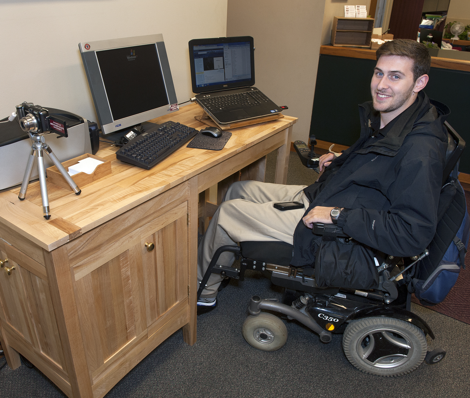 Will Graves, a junior history major at Mississippi State University, shows off the desk senior Morgan Welch designed and built for him.