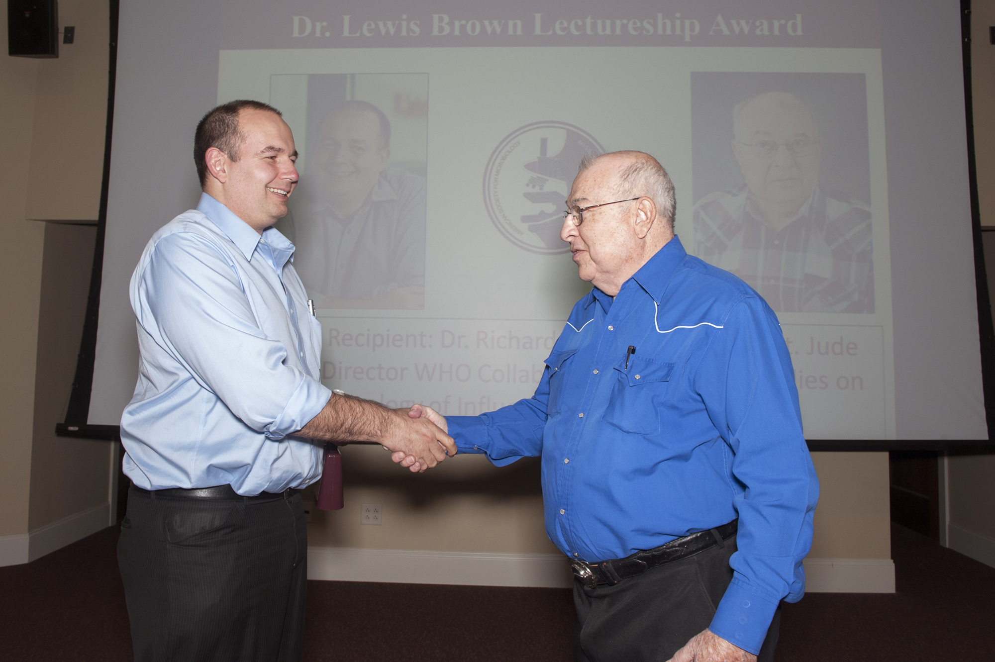 St. Jude's Research Hospital virologist Richard J. Webby, left, accepts the Dr. Lewis Brown Lectureship Award from Brown himself, a research professor emeritus at Mississippi State University. The award is sponsored by the MSU Student Chapter of the American Society for Microbiology.