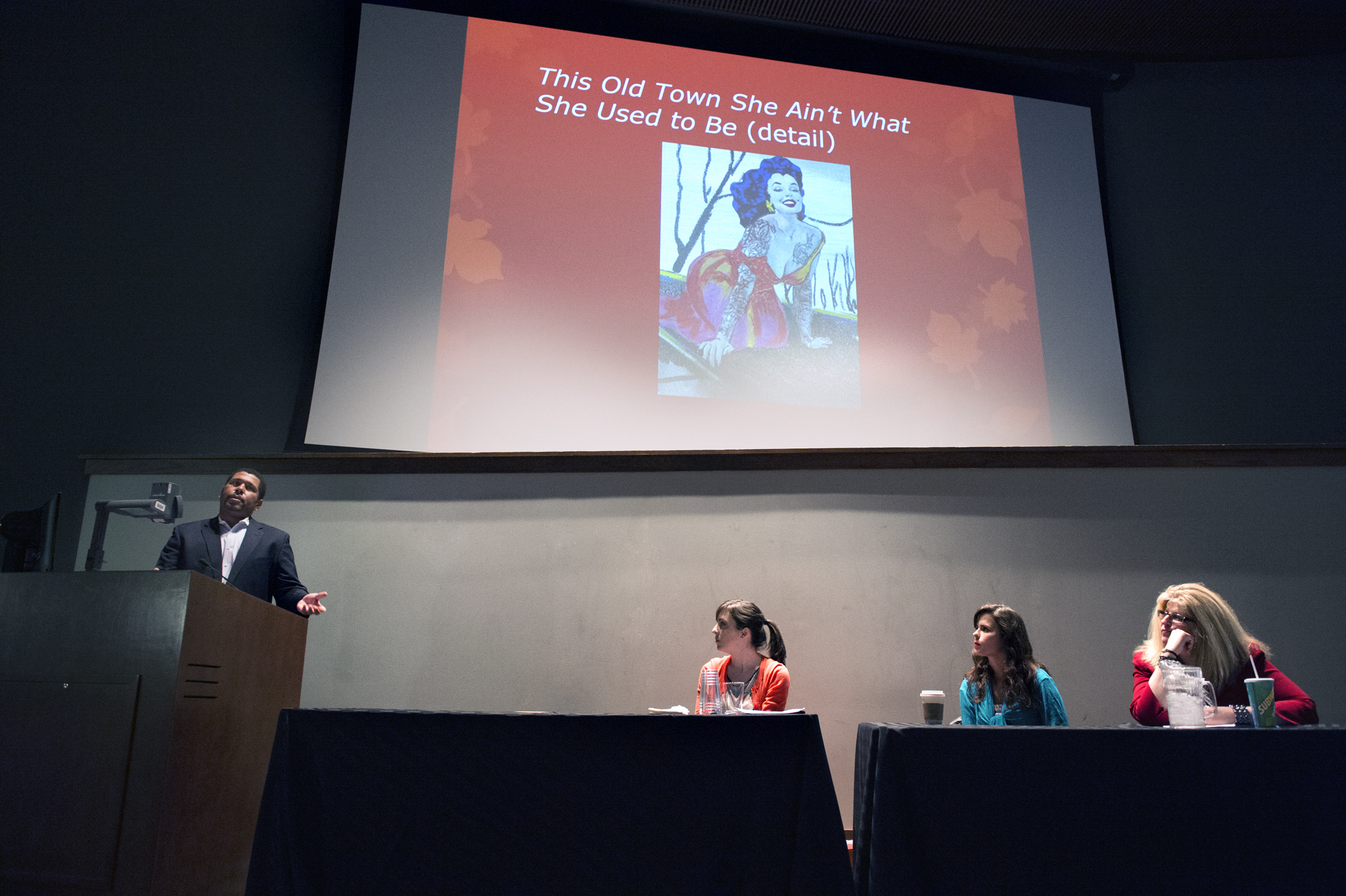 Mississippi State assistant professor Donald M. Shaffer Jr. poses a question during a panel presentation at the university's recent African-American Studies-sponsored Whiteness Symposium. Panelists include, from left, scholars Carly Houston and Anne Babson, and acrylics painter Samantha Baldwin.